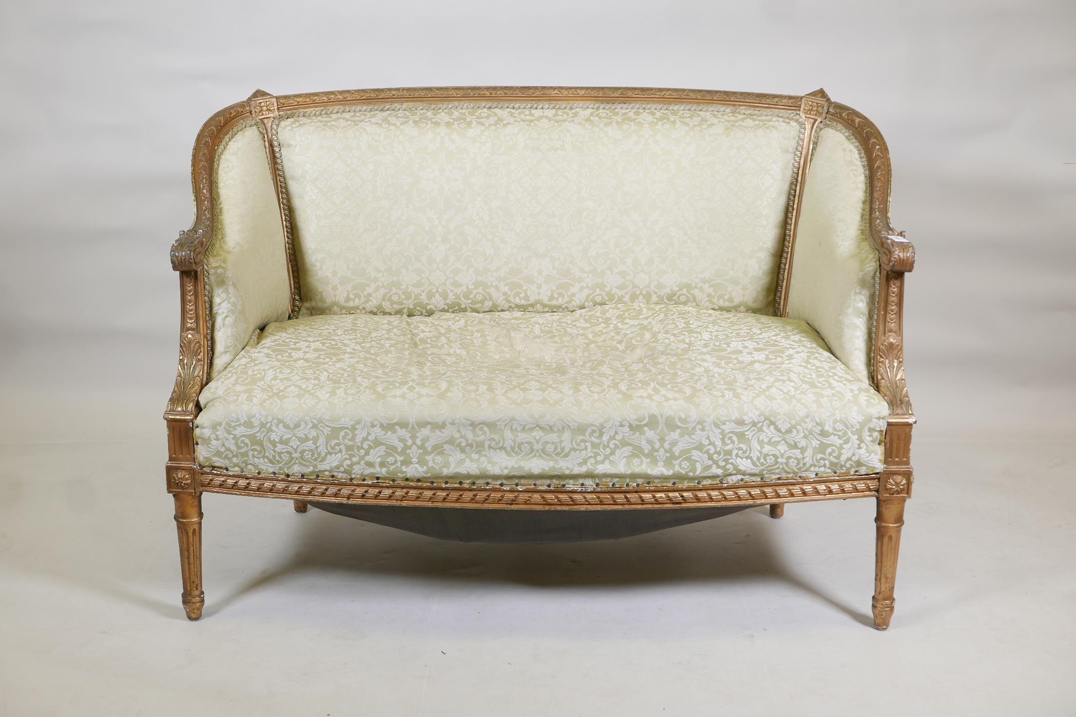 An early C20th giltwood canape, with moulded decoration, raised on fluted supports, 45" wide