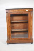 A Victorian inlaid walnut pier cabinet, with brass mounts and single glazed door, raised on turned