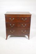 A C19th mahogany bachelor's chest raised on splay supports, with three long drawers and slide,