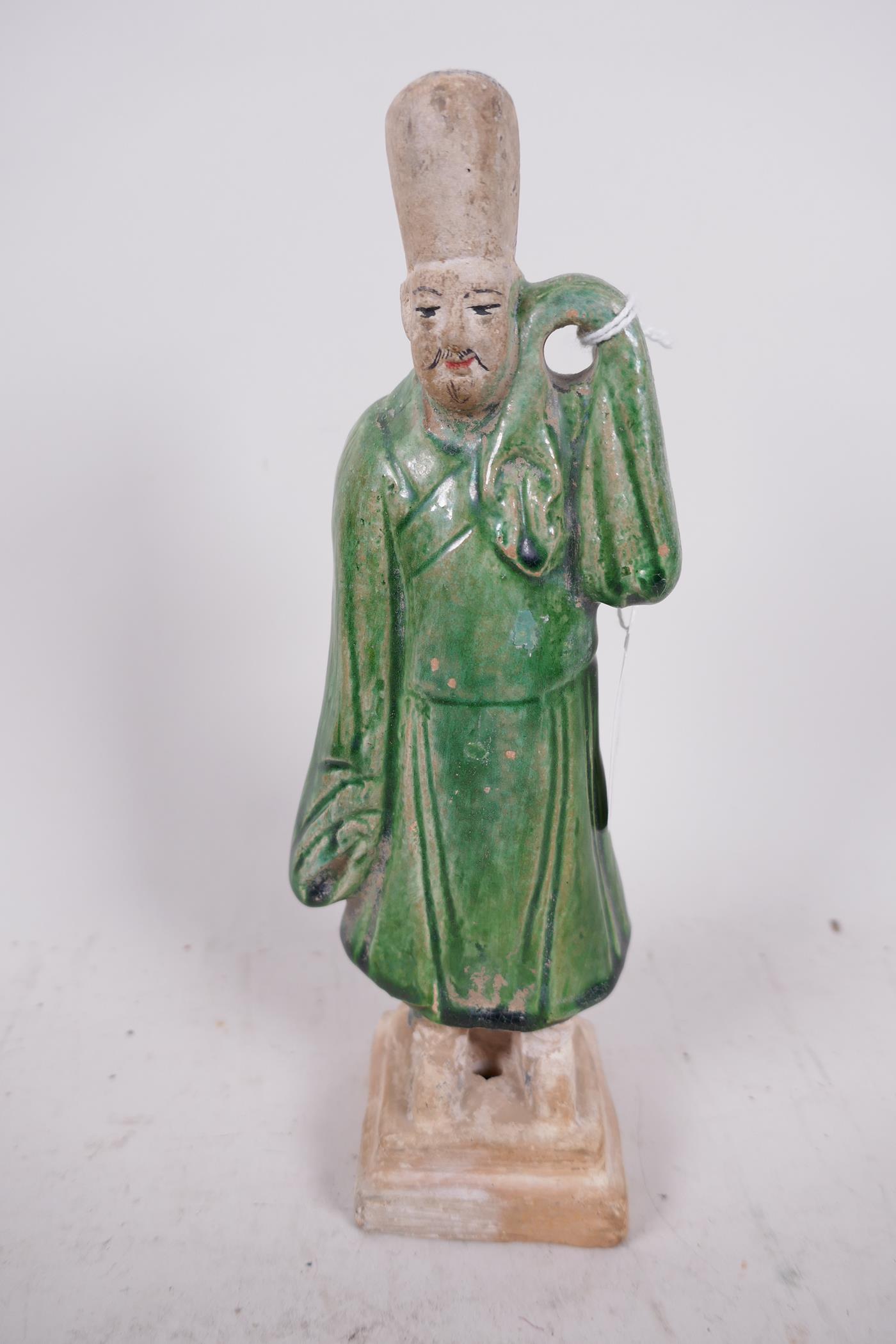A Chinese Tang dynasty (618-907AD) terracotta figure of a standing male court attendant, Sancai