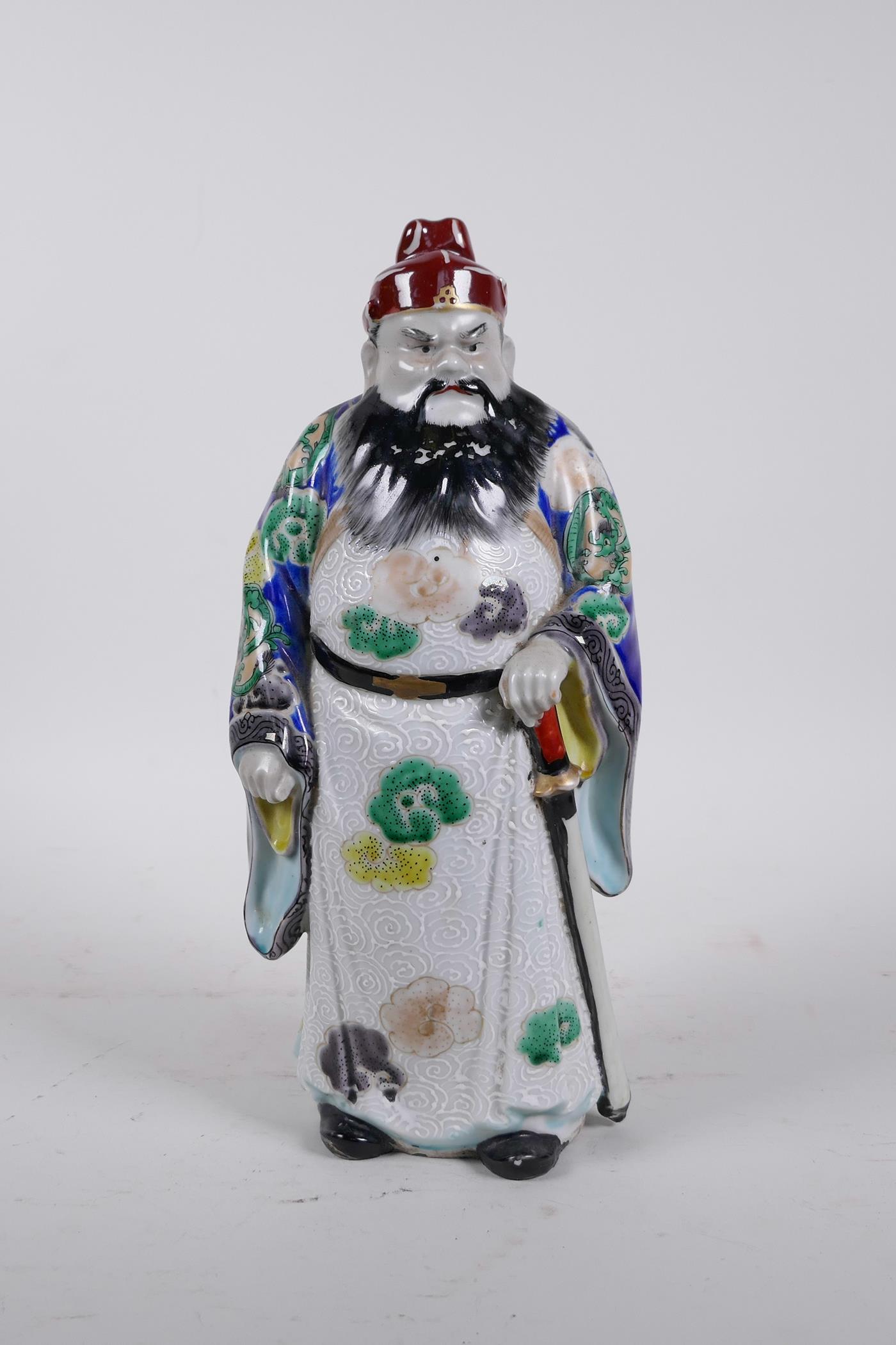 A Chinese polychrome porcelain figure of an Immortal, 11" high