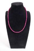 A 120ct ruby gemstone necklace, gilt clasp length 18"