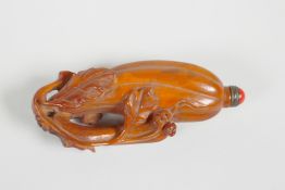 A Chinese carved deer horn snuff bottle in the form of a gourd, 3½" long