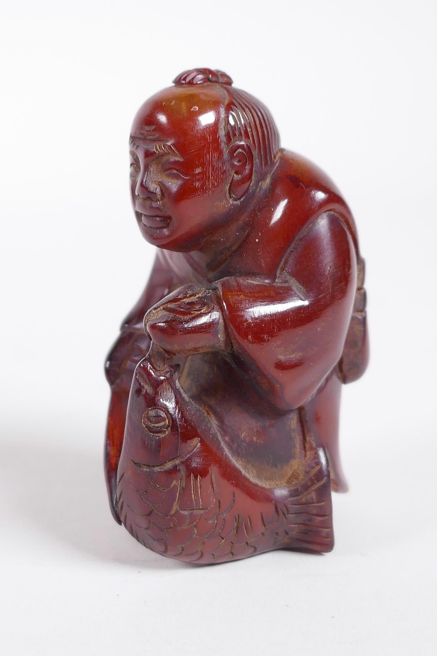 A Chinese carved horn figure of a fisherman, 2½"