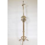 A brass floor lamp with fluted column and pierced globe decoration, 65" high