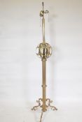 A brass floor lamp with fluted column and pierced globe decoration, 65" high