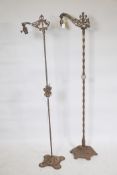 An early C20th cast iron floor lamp, with twisted column and pierced platform base, 57" high, and