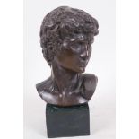 A bronze bust of David after the classical, mounted on a square base, 6¾" high