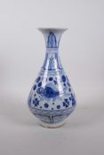A Chinese Ming style blue and white porcelain pear shaped vase with a flared rim, decorated with