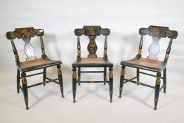 A set of three Baltimore side chairs with ebonised and stencilled parcel gilt decoration and caned