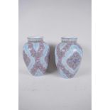A pair of Continental blue opaline glass vases with stylised enamelled decoration, 8" high