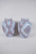 A pair of Continental blue opaline glass vases with stylised enamelled decoration, 8" high