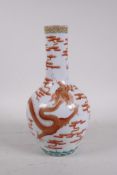 A Chinese polychrome porcelain bottle vase decorated with an iron red dragon chasing the flaming