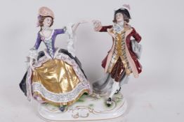 A Continental porcelain figure of a couple dancing, 9" high