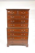 A mahogany chest on chest with cockbeaded drawers and brass handles, raised on bracket supports, mid