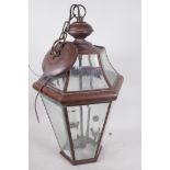 A copper pendant hall lantern with inset bevelled glass, 22" high