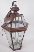A copper pendant hall lantern with inset bevelled glass, 22" high