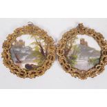 A pair of miniature landscape paintings on opaline glass depicting hilltop castles with rivers