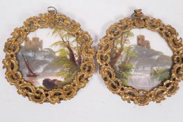 A pair of miniature landscape paintings on opaline glass depicting hilltop castles with rivers