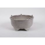 A Chinese celadon crackle glazed pottery censer raised on five supports, 7" diameter