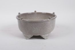 A Chinese celadon crackle glazed pottery censer raised on five supports, 7" diameter