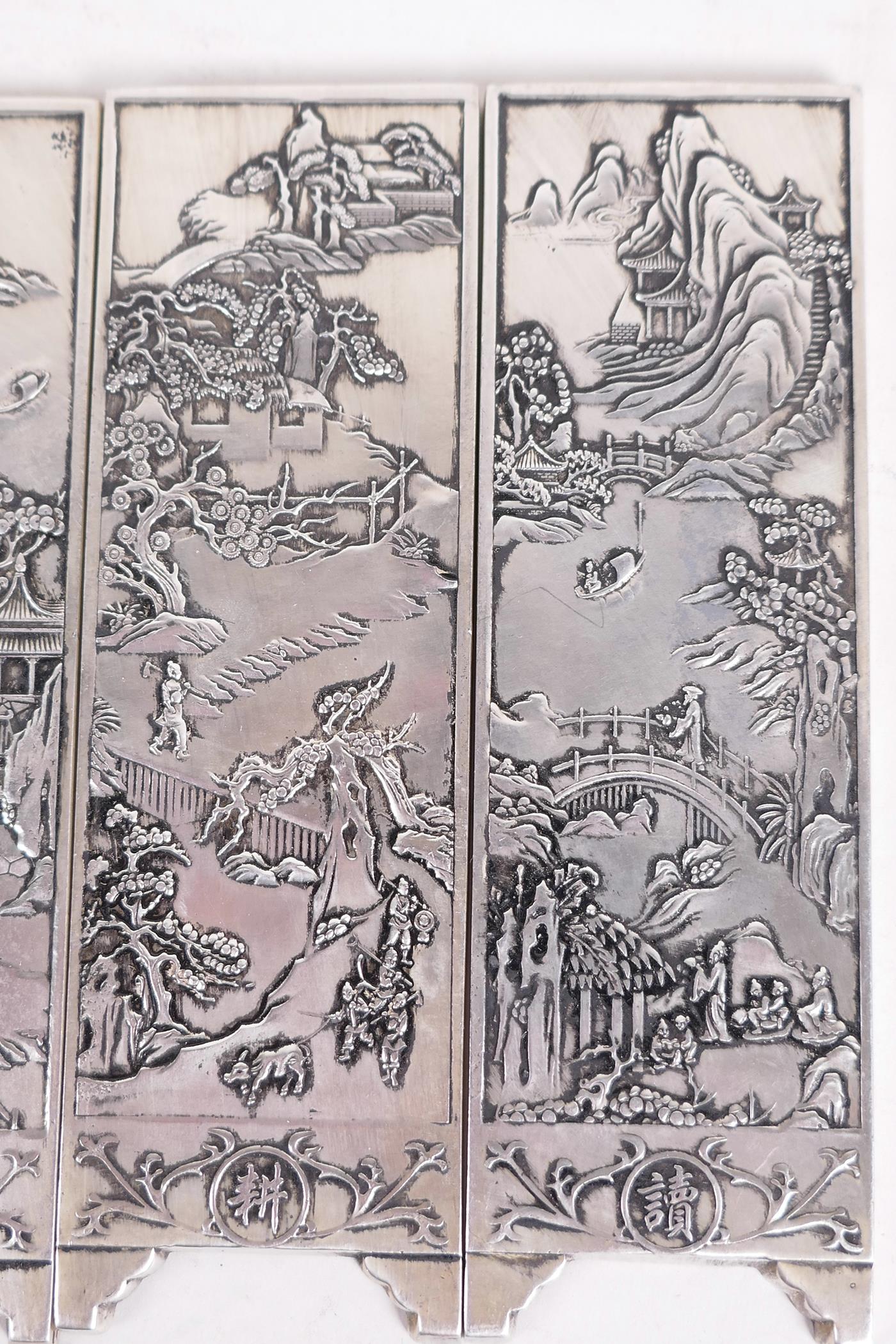 Four Chinese white metal scroll weights in the form of screen panels cast with landscape scenes, two - Image 3 of 4