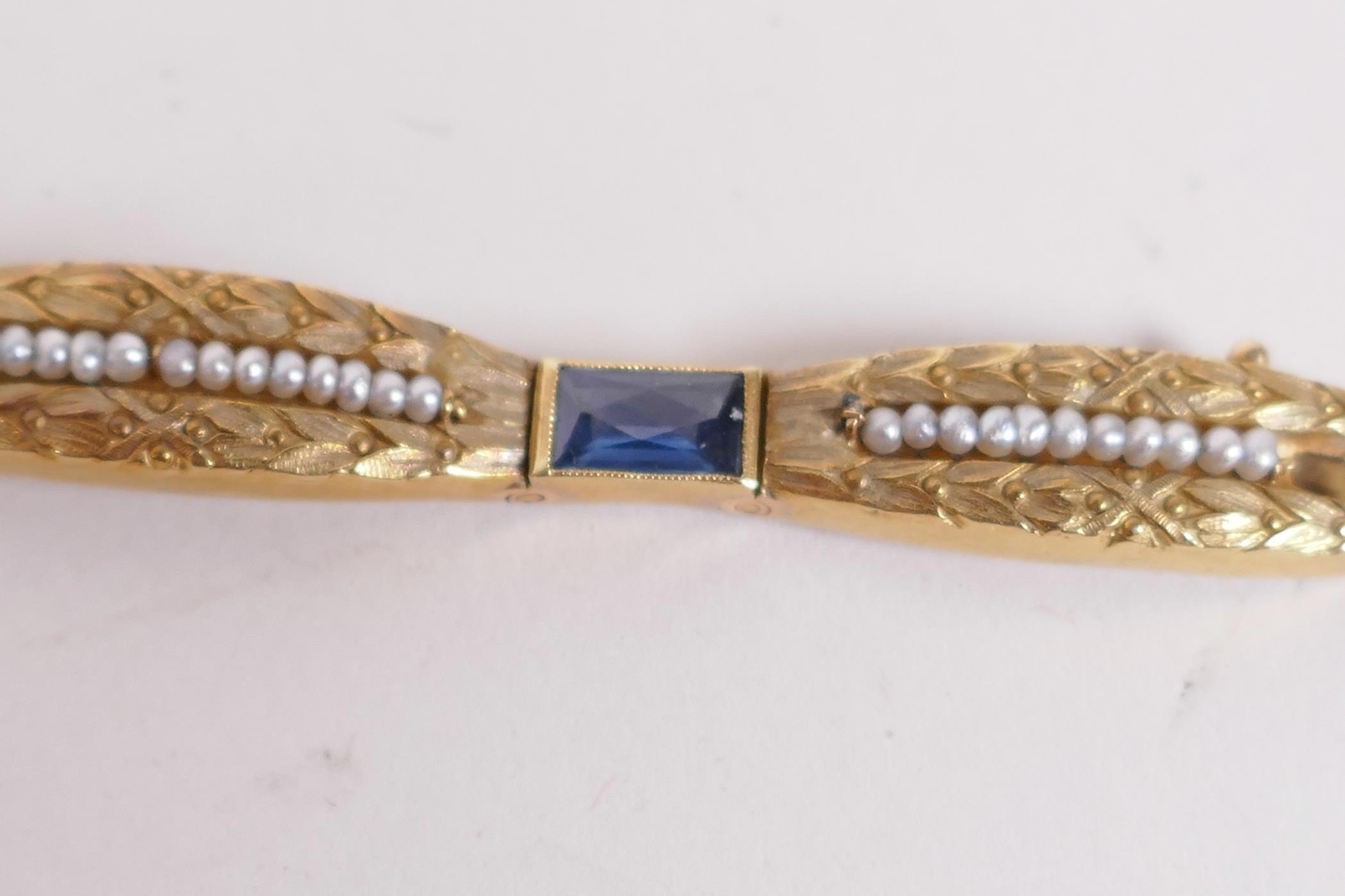 An 18ct gold bangle set with sapphires and seed pearls, and having bark finish engraving (15 grams - Image 5 of 6
