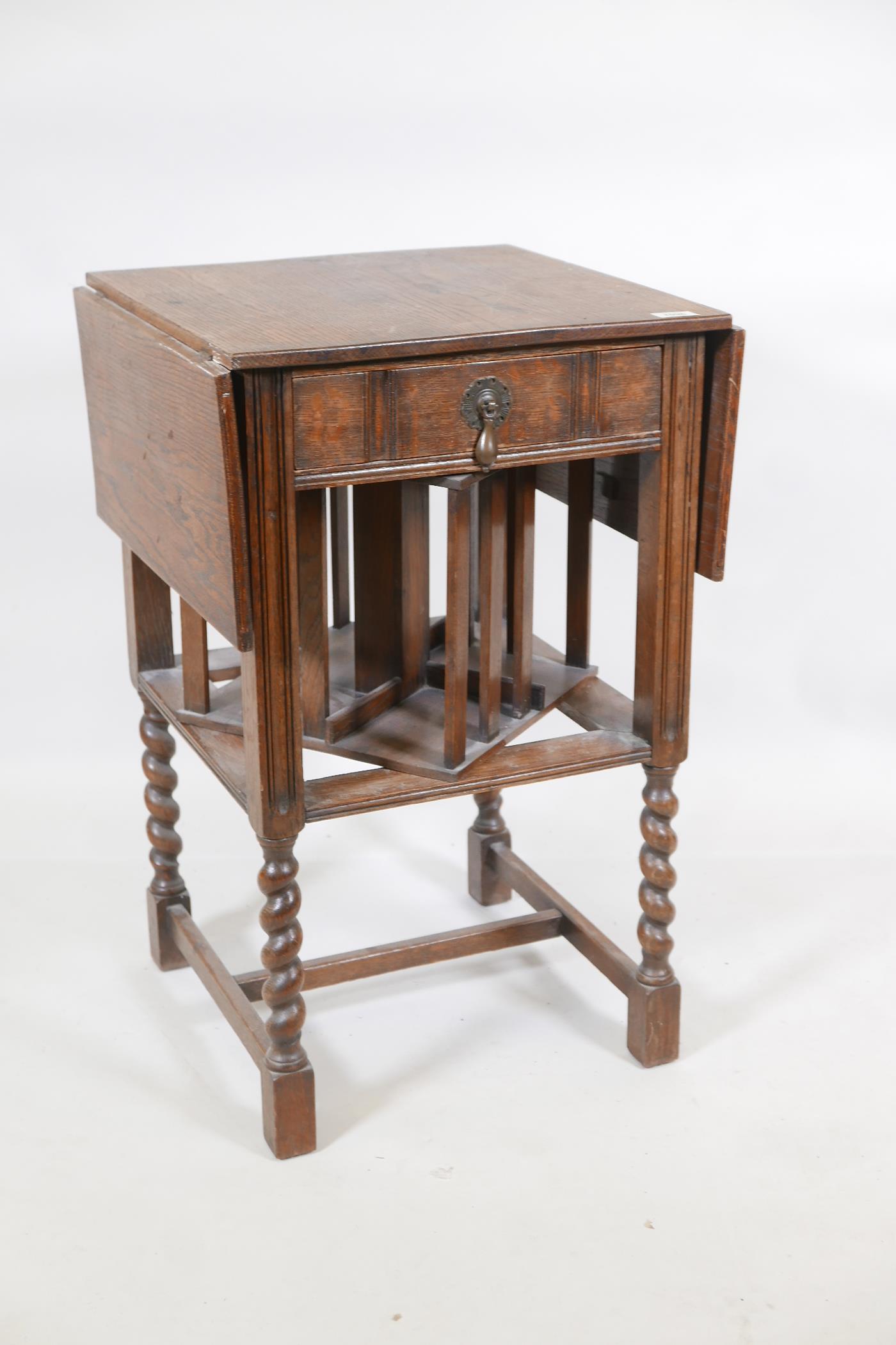 A Waring & Gillow oak dropleaf side table incorporating a revolving bookcase, raised on - Image 2 of 6