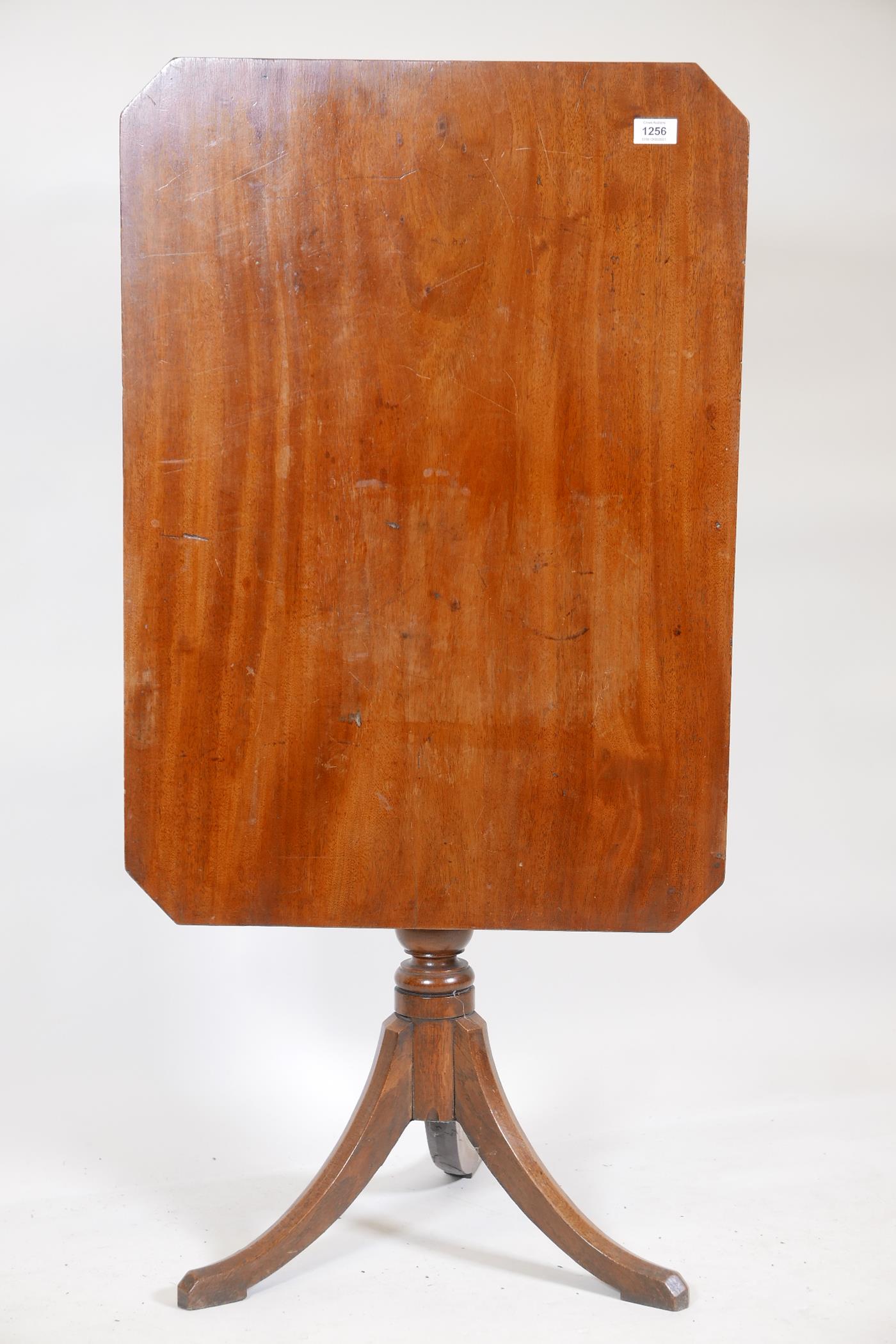 A C19th mahogany tilt top occasional table, with canted corner top, raised on turned column and