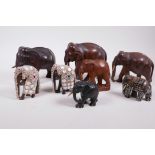 A collection of eight carved hardwood elephants, three dressed in ornamental ceremonial costume,