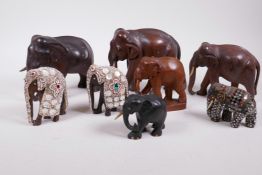 A collection of eight carved hardwood elephants, three dressed in ornamental ceremonial costume,