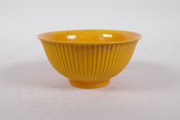 A Chinese yellow ground porcelain rice bowl with a ribbed exterior, 6 character mark to base, 5"