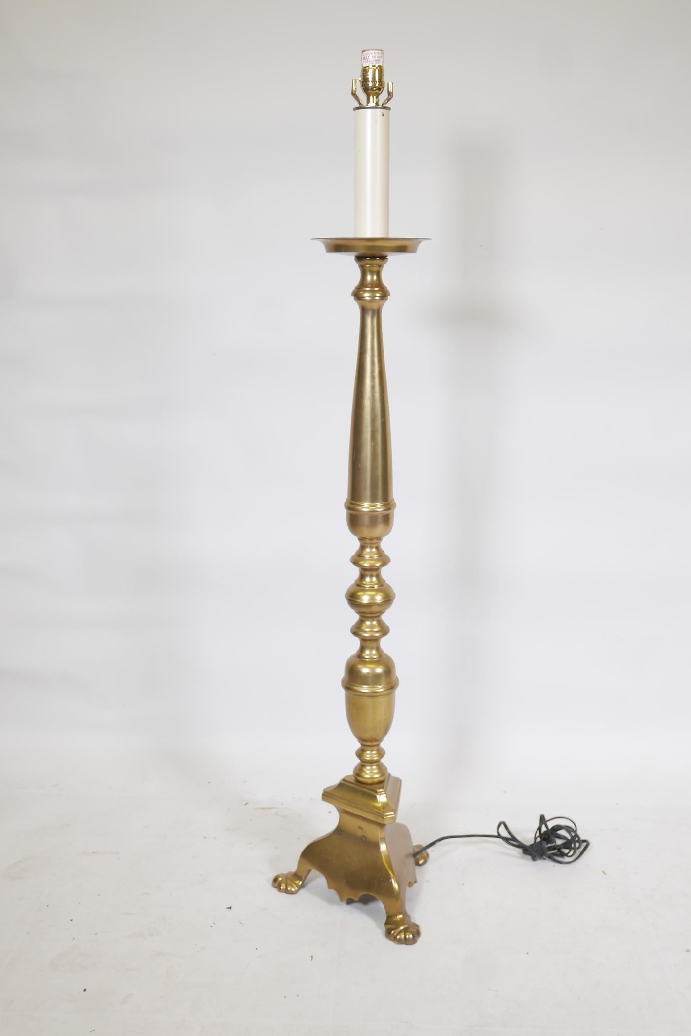 A polished brass floor lamp, 53" high