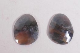 A 10.80ct and a 10.68ct near matching pair of natural sapphires, in bluish green, both oval mixed