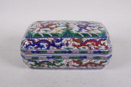 A Chinese wucai porcelain box and cover decorated with dragons and phoenix chasing the flaming