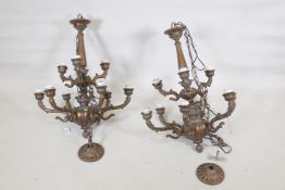 A pair of bronzed metal nine branch chandeliers, 33" high