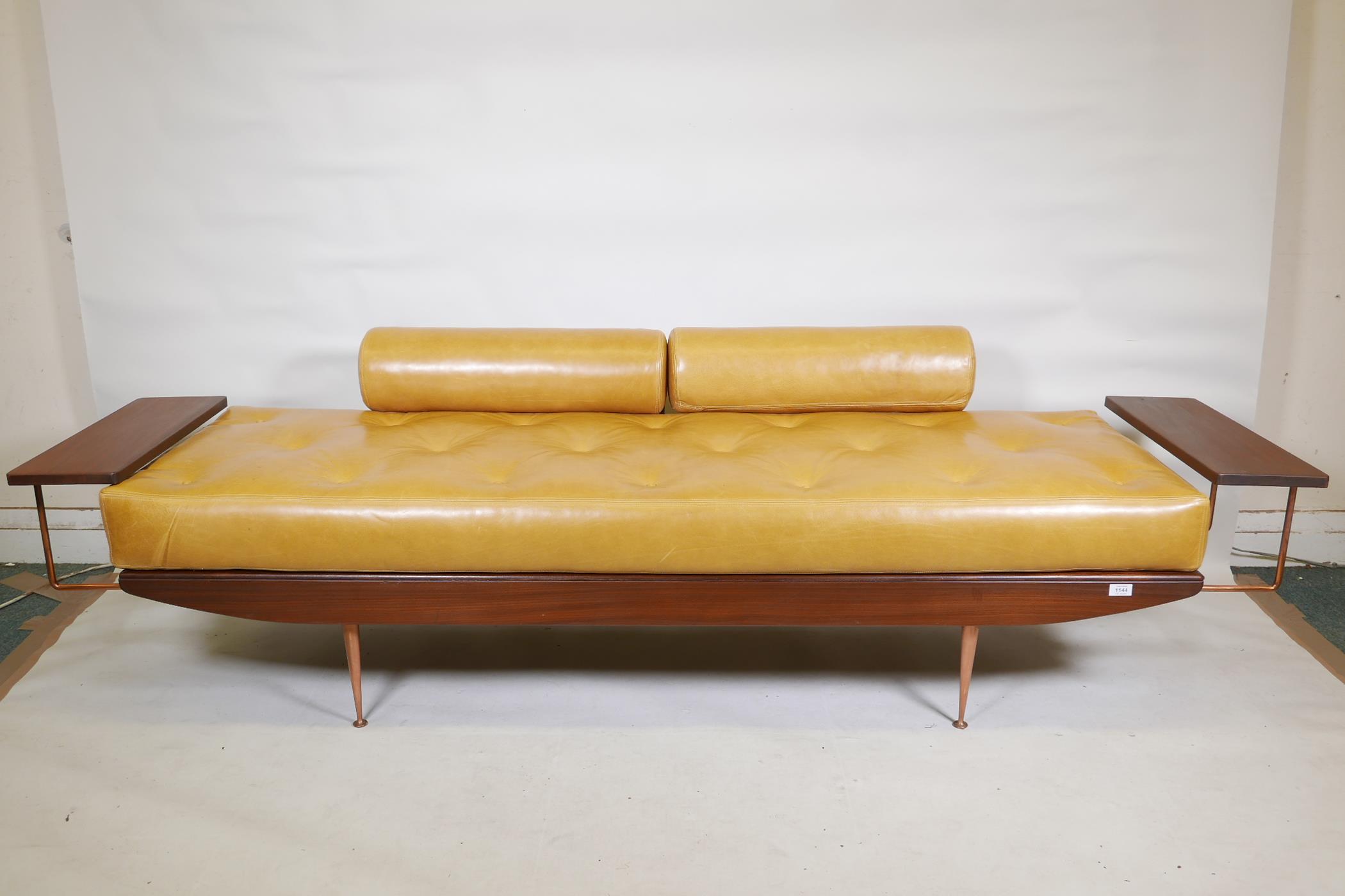 A rare 1950s British Toothill afromosia sofa bed, with buttoned mustard cushions, extending side