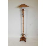 A 1960s bamboo and teak standard lamp with a rattan shade, 61" high