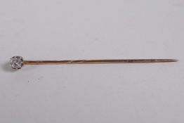 A diamond set gold stick pin, approximately ¼ct, 1.3 grams gross, 2" long