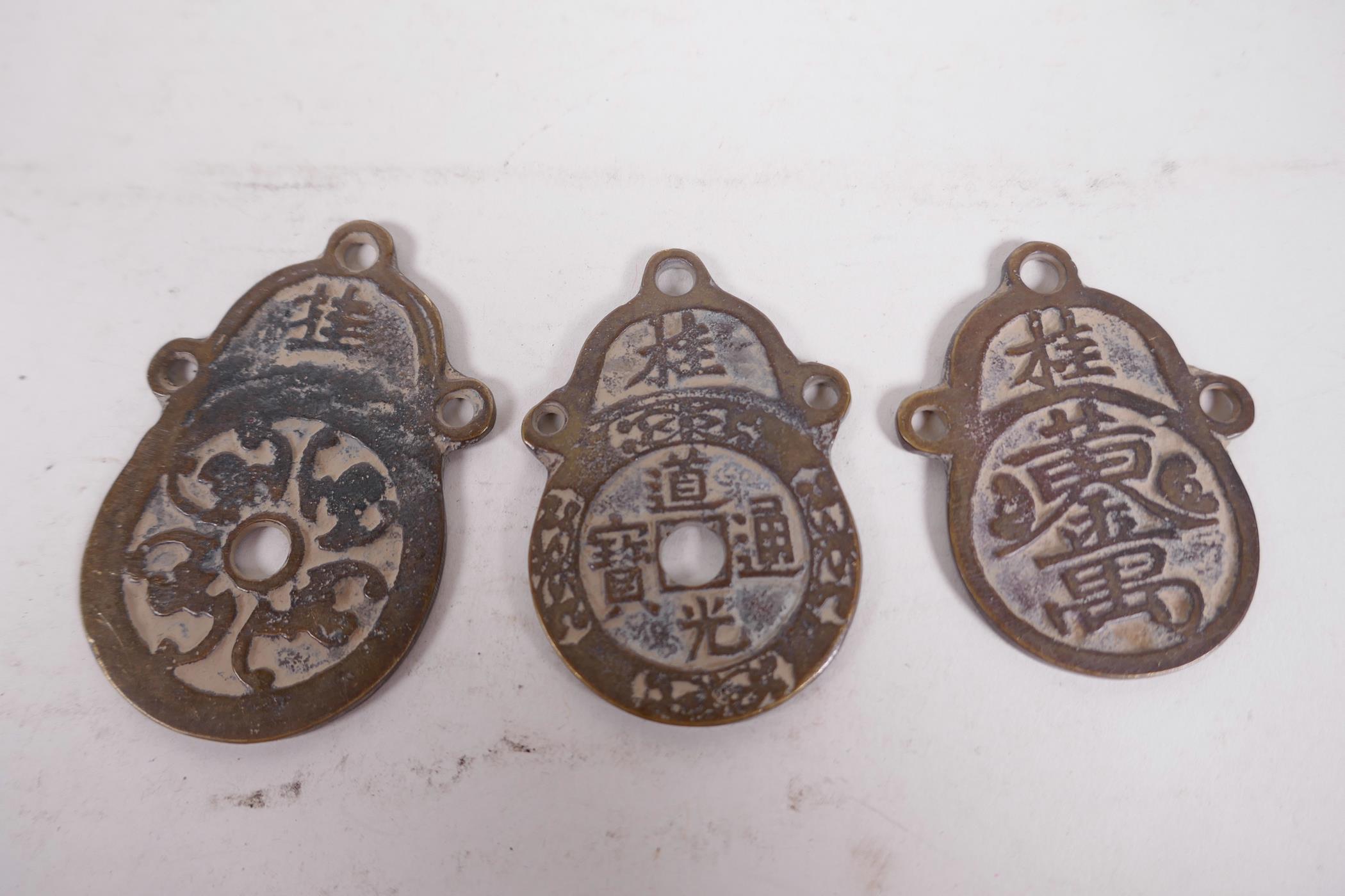 Three Chinese bronze graduated pendants decorated with calligraphy, largest 2¾" long - Image 2 of 2