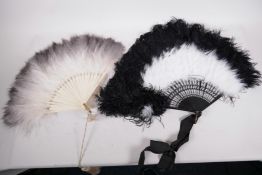 A black and white ostrich feather fan with silver decorated blades, 15" long, together with a grey