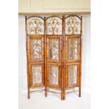 A vintage bamboo three fold screen with inset painted metal panels in Oriental frames, each fold 73"