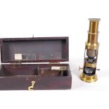 A small brass field microscope with slides, in a wooden box, 6¼" long