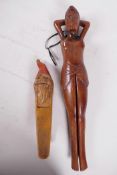 A carved hardwood nutcracker in the form of a female nude 13" long, together with another carved