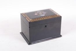 A C19th papier mache lacquered two division tea caddy with inlaid mother of pearl and gilt an enamel