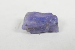 An 8.11ct natural tanzanite, rough cut, IDT certified, with certificate