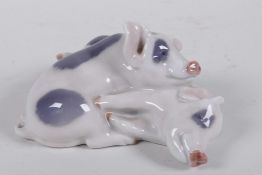 A Royal Copenhagen porcelain figure of two pigs, no.683, 5" long