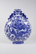 A Chinese blue and white porcelain two handled moon flask decorated with a dragon clutching the