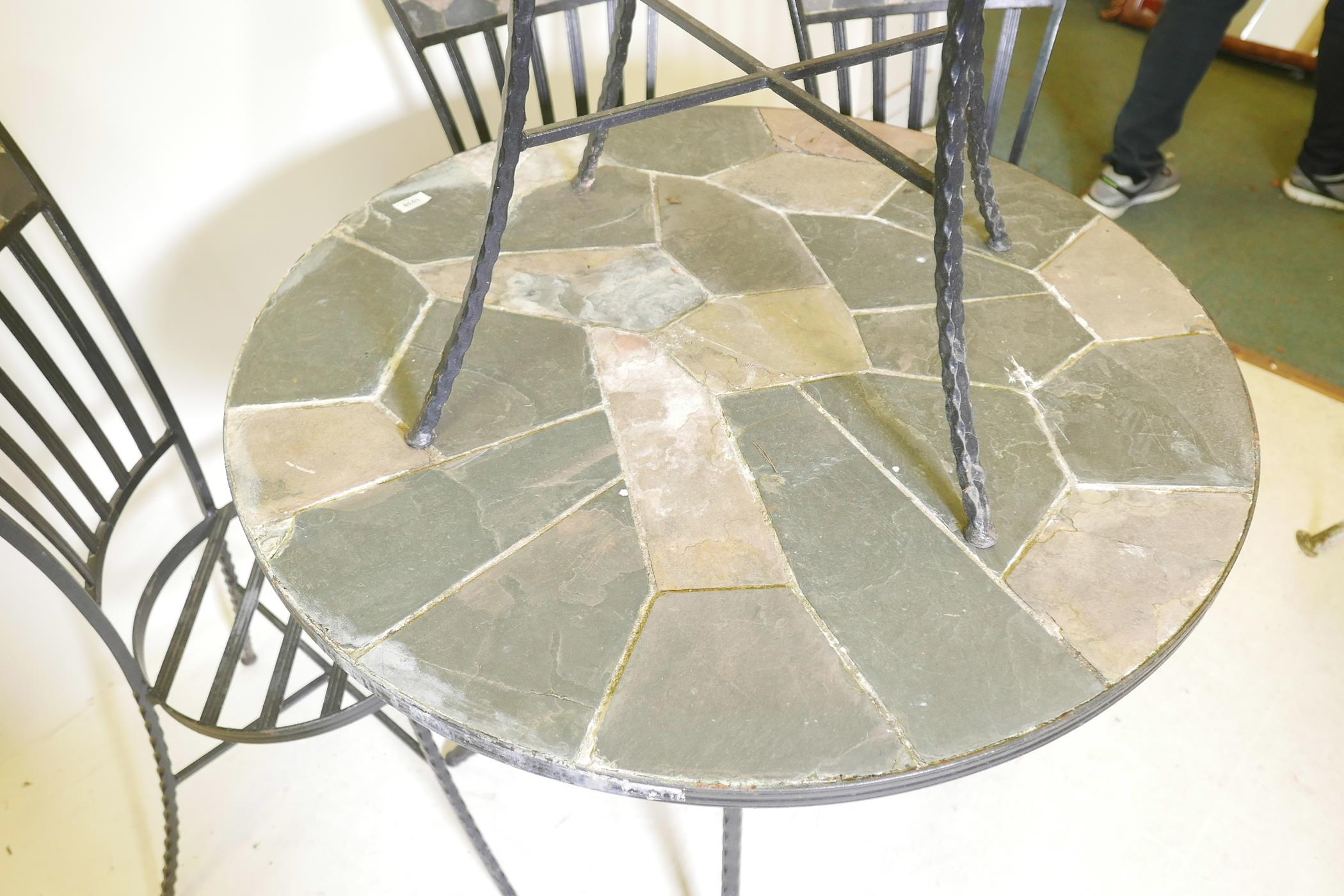 A circular wrought iron and slate garden table on twisted supports, 30" high, 36" diameter, together - Image 3 of 4