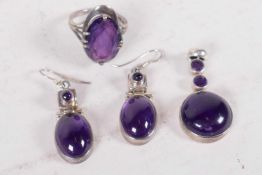 A suite of silver and cabochon amethyst jewellery, finger ring, earrings and pendant